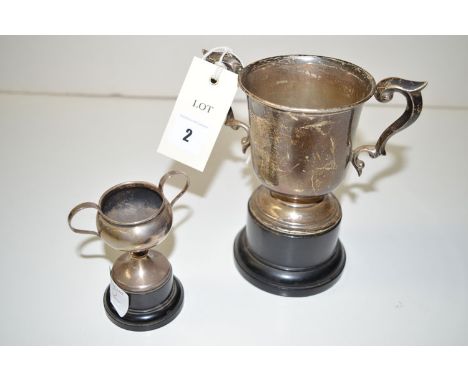 A pair of silver trophy cups, each with scrolling handles and Masonic golf challenge inscription, on ebonised bases, the cups