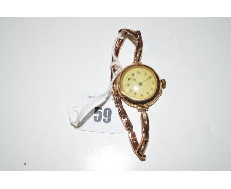 A 9ct. gold wristwatch, the white enamel arabic dial on flexi baton strap.