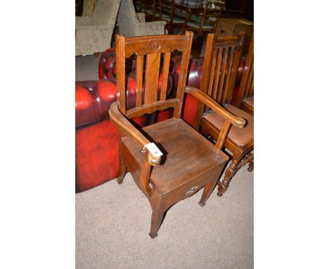 A stained wood commode chair, fitted ceramic liner to inside seat.