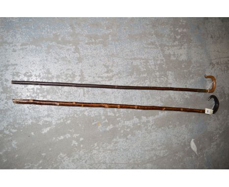 A shepherd's rustic stick with buffalo horn handle; together with another hazel stick with shaped wooden handle, probably hol