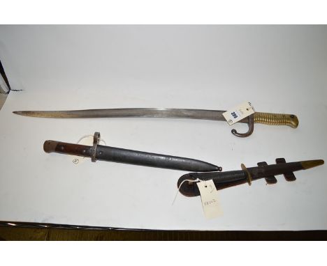 A Commando Stiletto in leather sheath; a small mid/late 20th Century bayonet with metal sheath and wooden handle; and a Frenc