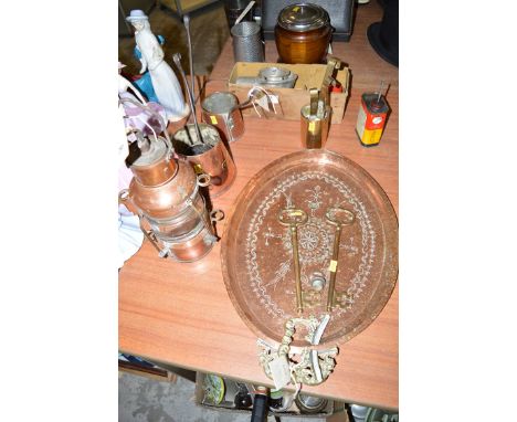 Copper ware: a boat's masthead lamp; measuring jugs and ladles; an oval tray with brass handles; two large brass que's; and a