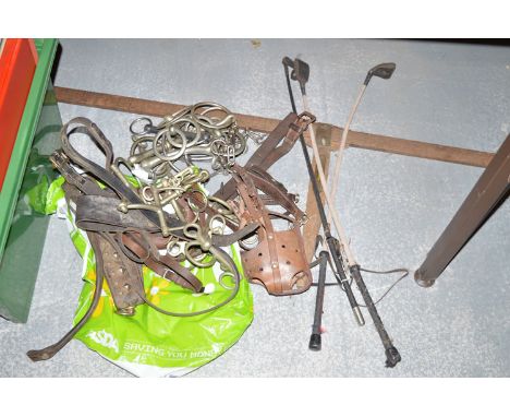 Three riding crops; a horse measuring stick; and a quantity of leather tack in a bag.