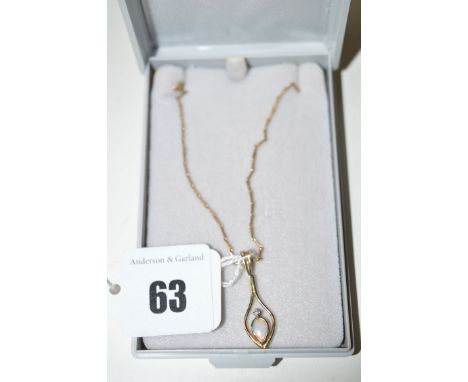 An opal and diamond set drop pendant on chain.