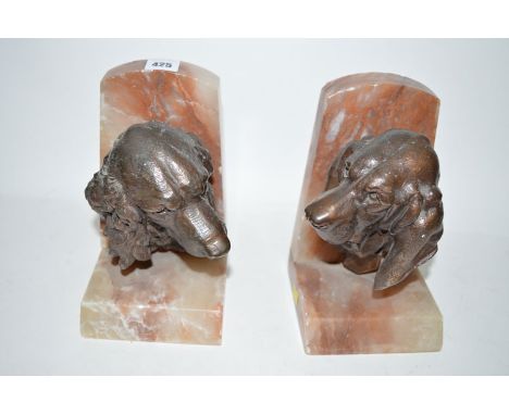 A pair of bronze effect and marble book ends, in the form of dogs' heads, inscribed on the collar Lecortier (1930's)