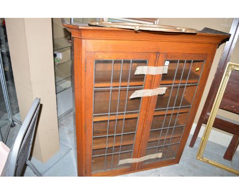 A late 19th Century oak bookcase top, with flared cornice and two leaded glass panel doors enclosing shelves.