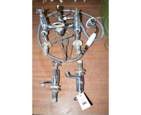 An early 20th Century chromed shower bath mixer tap; and a pair of basin taps to match.