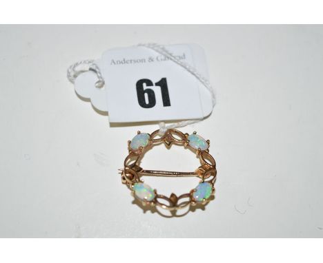 An opal and 9ct. yellow gold wreath pattern brooch, with openwork design.