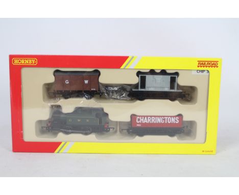 Hornby - A OO Gauge Railroad Train Pack # R2670 containing an 0-4-0 tank engine number 104 in GWR livery and three wagons. Th