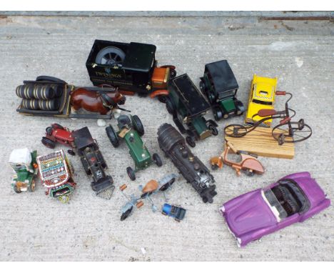 A collection of decorative tinplate / pressed metal, wood and other material models depicting a variety of vehicles in variou