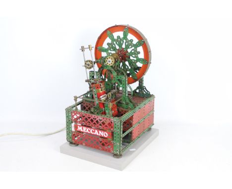 Meccano - A vintage red and green Meccano shop display model of a Decorative Wheel. The electric model is mounted on a grey b