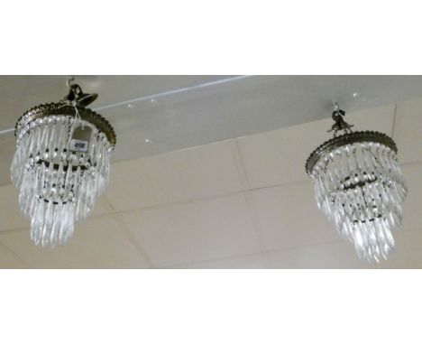 A pair of hanging glass electric light pendants 