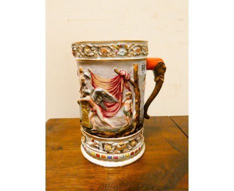 A Capo di Monte figure decorated mug with elephant trunk handle