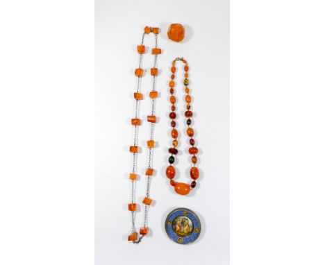 Amber bead necklaces, large faceted amber bead and an enamel circular silver brooch decorated with classical scene.