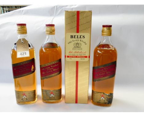 Four bottles of Bell's, Johnny Walker Old Scotch Whisky, one is boxed 