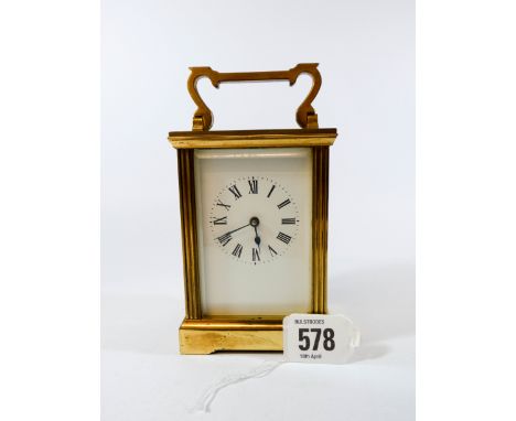 A brass carriage clock, approximately 15cm tall complete with key