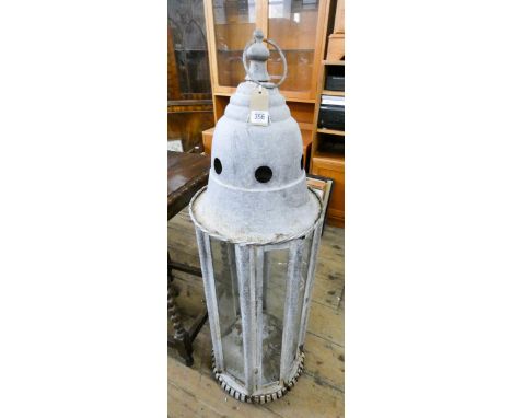 A large galvanized hanging outdoor glazed lantern 