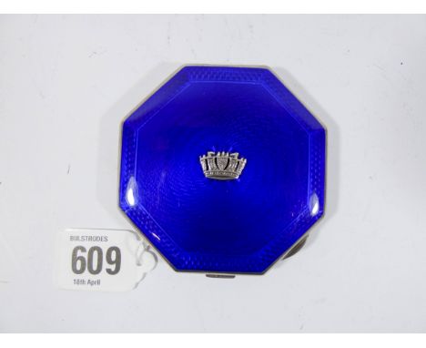 A silver octagonal compact with engine turned decoration and deep blue enamel, mounted with crest of the Merchant Navy, hallm