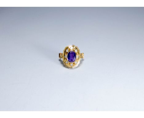 18ct gold Middle Eastern dress ring set with an oval amethyst ring size 'i' 