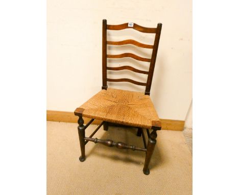 An antique oak ladder back dining chair with rush seat 