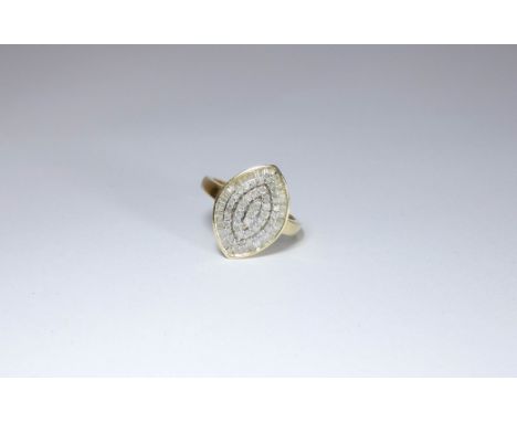 Large diamond cluster ring, set with brilliant and baguette cut diamonds in a diamond shaped panel. Ring size N