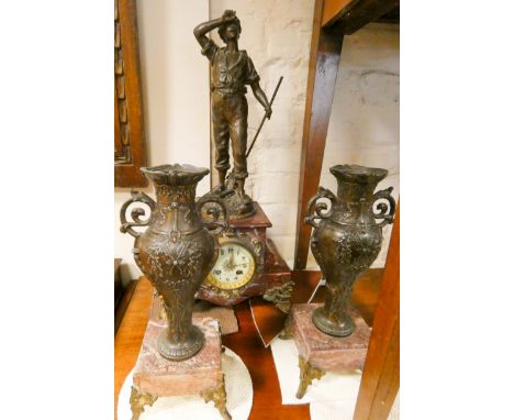 A French striking mantel clock with spelter figure mount in rouge marble and gilt metal case together with a pair of similar 