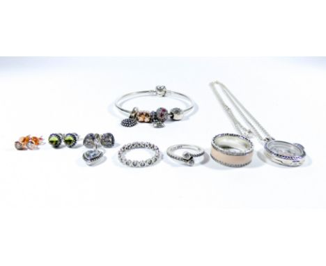 A collection of Pandora jewellery to include a floating locket necklace with four charms, a bangle with five charms, three ri