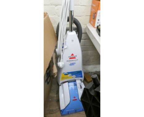 A Bissell power wash deluxe carpet cleaner