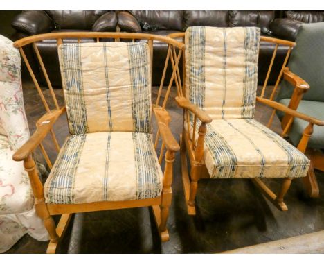A pair of pale oak Ercol rocking elbow chairs with loose cushions 