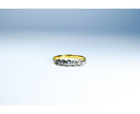 A five stone diamond ring set with brilliant cut diamonds in a rub over setting, shank stamp 18ct ring size O