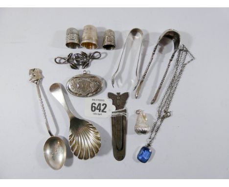 A collection of small silver items to include shell shaped caddy spoon, thimbles, book mark, locket, sugar tongs etc, approxi