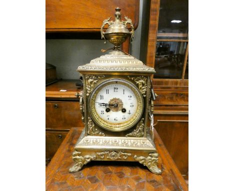 A French striking mantel clock by Japy Freres in decorative brass case with urn shaped finial