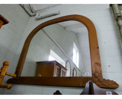 A large pine framed domed topped over mantel mirror 
