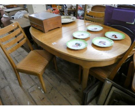 An oval Nathan pale teak extending dining table with fold away centre leaf and four matching ladder back style chairs 