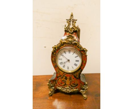 A Buhl brass mounted mantel clock with white enamel dial 12" tall