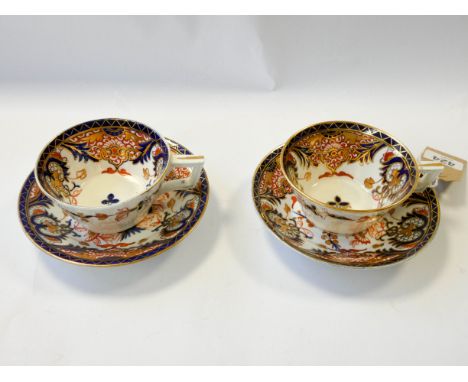 A pair of Imari style porcelain cabinet cups and saucers, marks to the base crown and cypher  