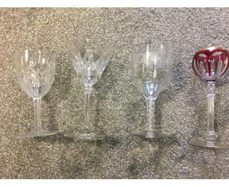 Four 19th c wine glasses, to include ribbon twist wine and grape engraved example, red and gilded example and two hand cut ex