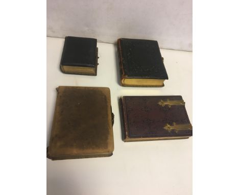 Four Victorian photo albums, with family portrait photos.