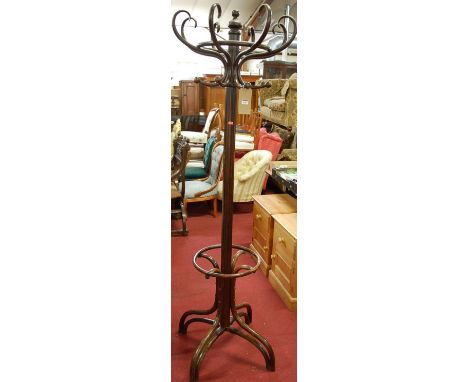 A stained bent wood hat stand in the manner of Thonet, having eight S-scroll hooks on umbrella lower supports, height 195cm. 