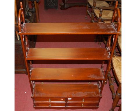 A reproduction mahogany four tier hanging wall shelf, having four short lower drawers, w.71.5cm. Height 112cm.