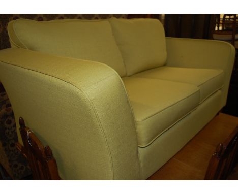 A contemporary Marks &amp; Spencer lime green upholstered two-seater sofa, w.168cm