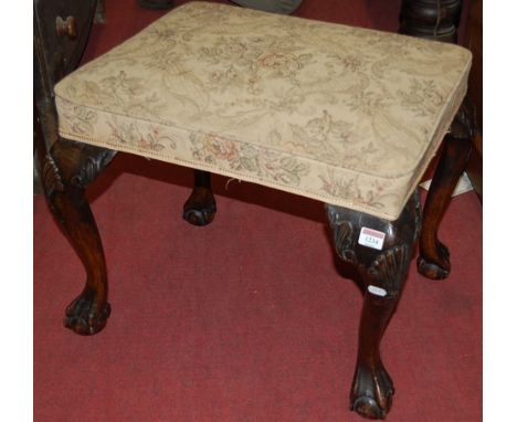 A 19th century walnut and floral tapestry upholstered dressing stool in the early Georgian taste, raised on shell capped cabr