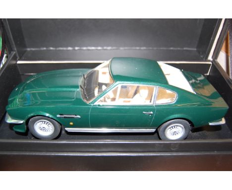 A 1/18 scale boxed model of a 1977 Aston Martin V8 Vantage finished in metallic green (missing one wing mirror), housed in th