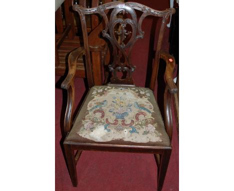 A set of five Chippendale style relief floral carved mahogany splatback dining chairs, each having tapestry floral upholstere