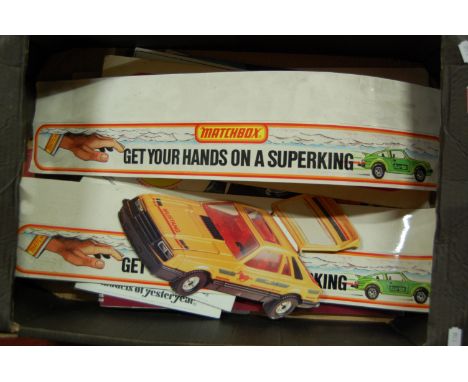 One box containing a quantity of vintage Matchbox point of sale advertising signs and accessories