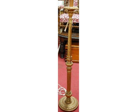A gilt wood spiral and plain fluted standard lamp, raised on circular stepped base, height (excluding fittings) 145cm