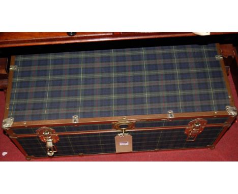 A metal bound and tartan clad travelling trunk having end carry handles, width 77cm
