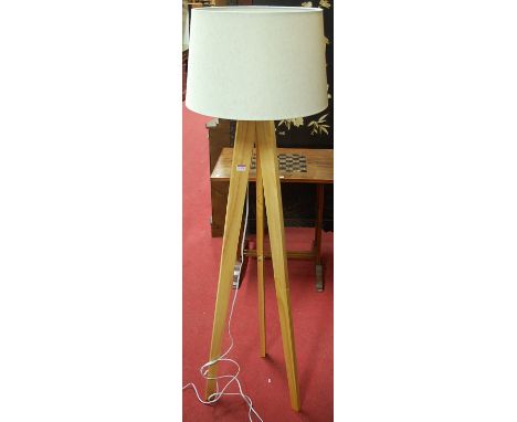 A contemporary beech standard lamp, on three tapering supports; together with white wood French style oval wall mirror (2)