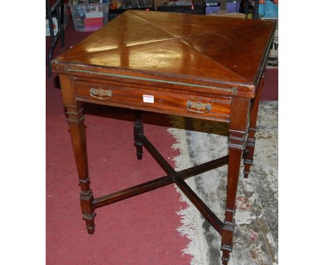 An Edwardian mahogany envelope card table, having single frieze drawer, raised on square tapering supports to X-frame stretch