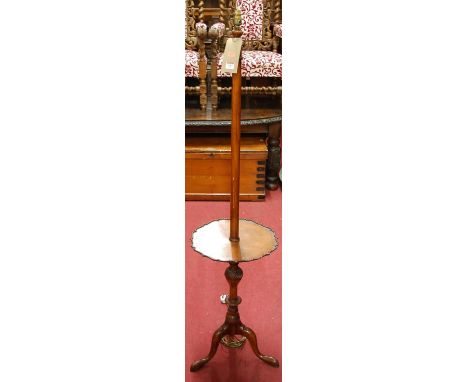 A Georgian style walnut standard lamp, having piecrust dished central platform and on hipped cabriole supports, height (exclu